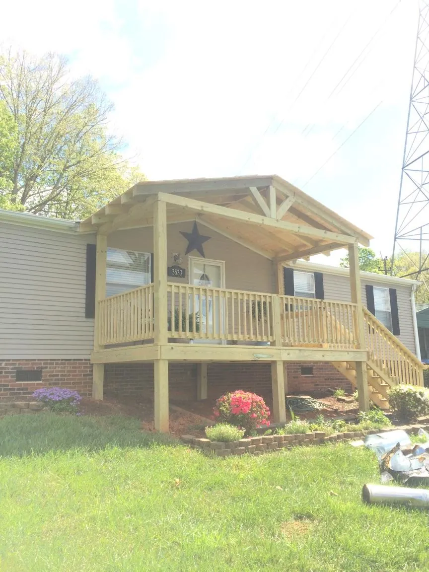 New gabled porch roof and deck railing added to a ranch home in Heron